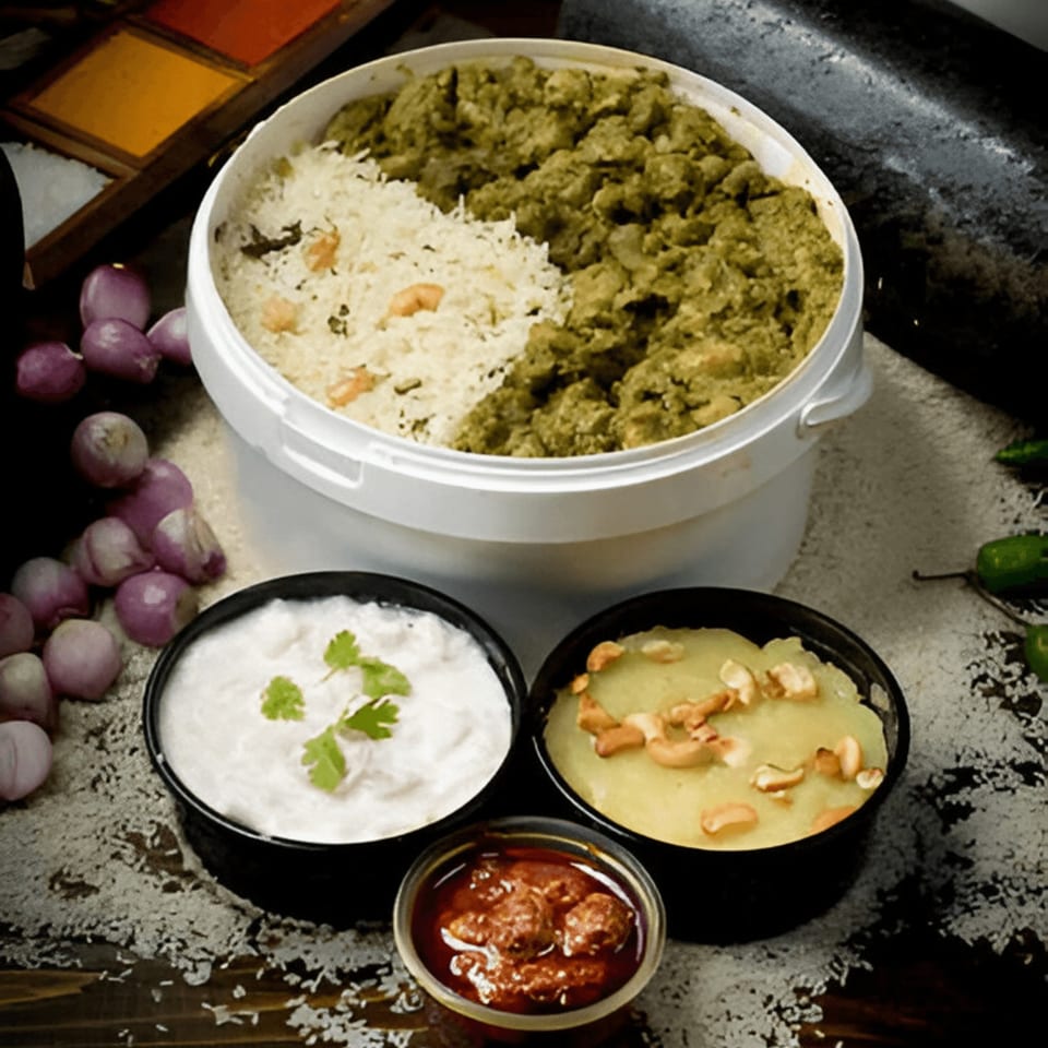 Indian meal with rice, green curry, yogurt, sweet pudding, and pickle, surrounded by ingredients.