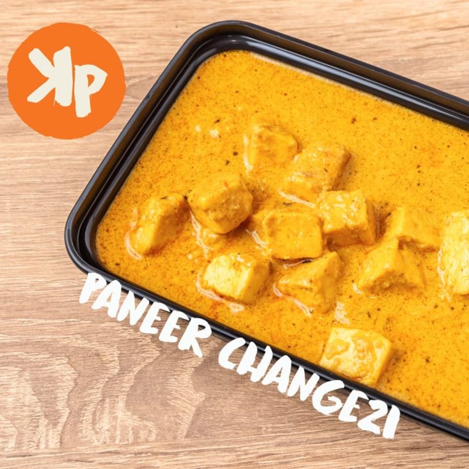 Kolapasi Indian Canteen's Paneer Changezi, a rich orange curry with paneer cubes in a black container.